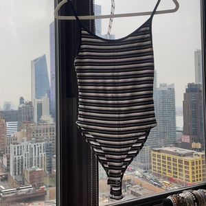 Striped black body suit.